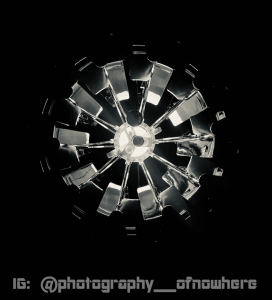 black and white photography of bladed spokes radiating from a bright hub