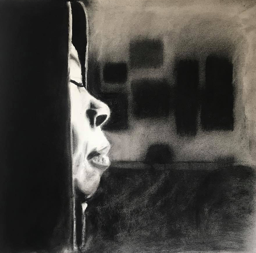 Charcoal drawing of a profile in light, emerging from behind a dark surface